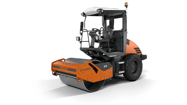 Vibrant orange construction roller parked on green background.